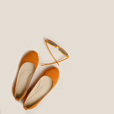 Fashion accessories for the beach - shoes and orange glasses  on a white background. Selective focus.の写真素材
