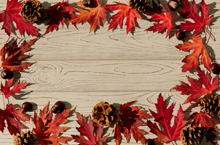 Autumn colors. Red maple leaves on gray wooden background. Selective focus. Blur effect.