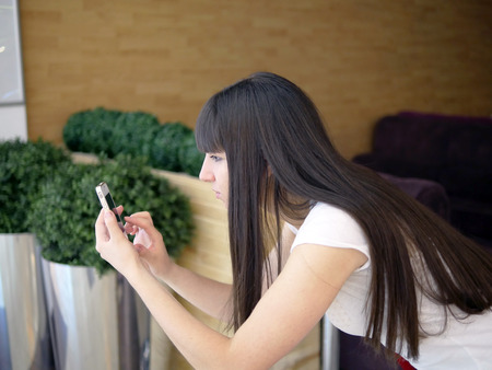 Girl play the popular smartphone gameの写真素材