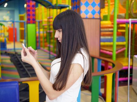 Girl play the popular smartphone gameの写真素材