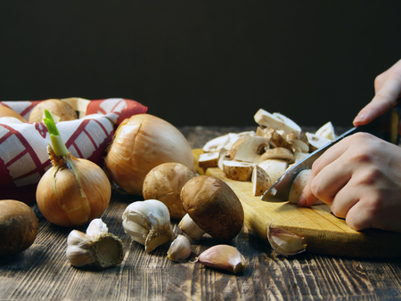Cooking - cutting mushrooms in the kitchen.の写真素材