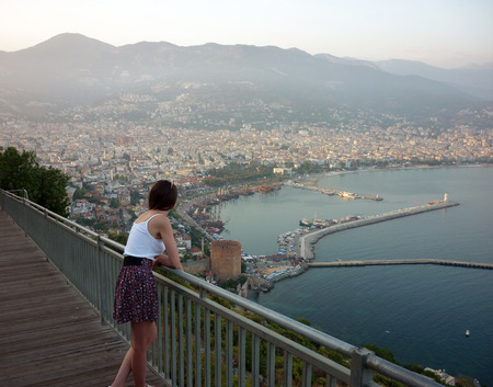 Beautiful woman looking to townの写真素材