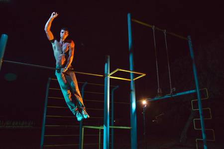 Athlete doing exercises on the horizontal bar