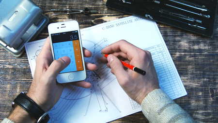 Man using smart phone as a calculator