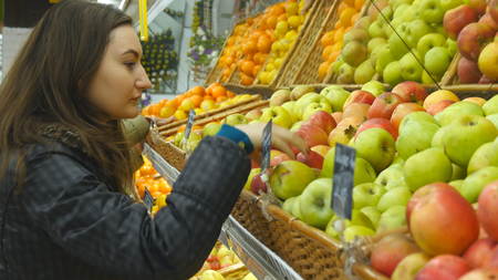 Choosing and buying apples at the store