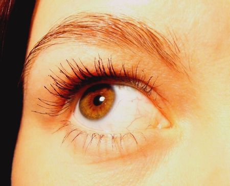 close-up girl's brown almond-shaped eyeの写真素材