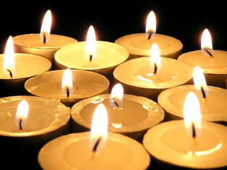 fired wax candles in darknessの写真素材