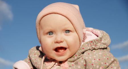 baby girl is delighted with something, looks in cameraの写真素材