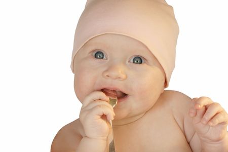 cute baby playing with silver spoon, isolated on white backgroundの写真素材