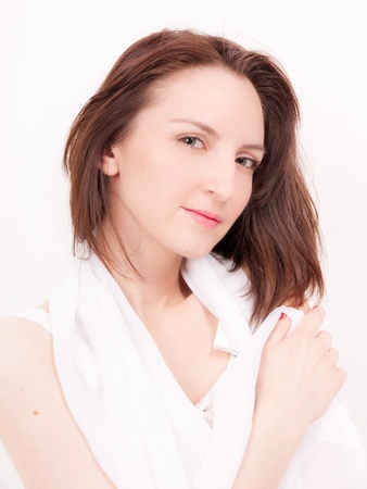 beautiful brunette portrait in silk white scarfの写真素材