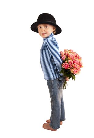 funny cute child with hidden bunch of roses on white backgroundの写真素材