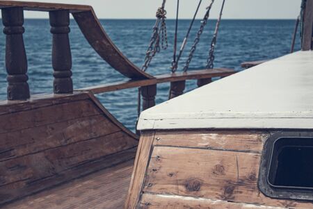 View from the front of the old wooden ship. The bow of a vintage ship. Window in cabin and the lower...