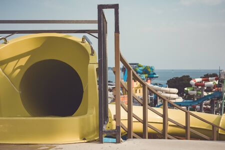 Closed yellow water slide on the background of the water park