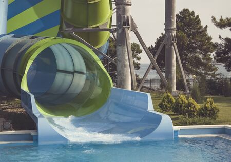 Big striped water slide for extreme descents on an inflatable circle in the water Parkの写真素材