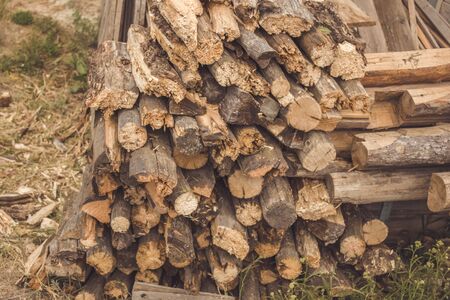 A sheaf of stacked wood, chopped with an axe. Harvesting fuel for the furnace in winter. A big pile...