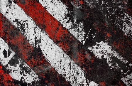 Striped damaged texture with cracks and white-red stripes.Post-apocalyptic background with colorful stripes. Destroyed sign dimensional transport with cracks and spots.の写真素材