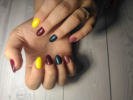 Multicolored gel varnish. High-quality manicure on women's nails with colorful design. Extended round nailsの写真素材