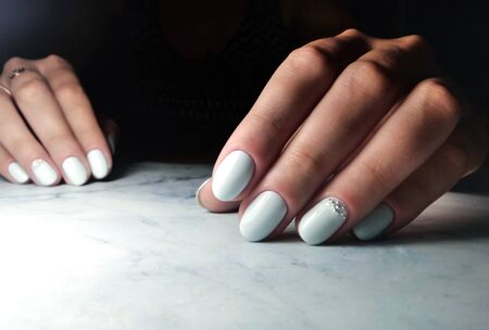 Delicate blue manicure with rhinestone designの写真素材