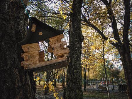 Birdhouse for birds hanging tied to a tree. House for birds with a through passage. Handwork.