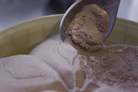 A bucket of chocolate ice cream with a spoon. Spoon took the ice cream with the taste of chocolate....