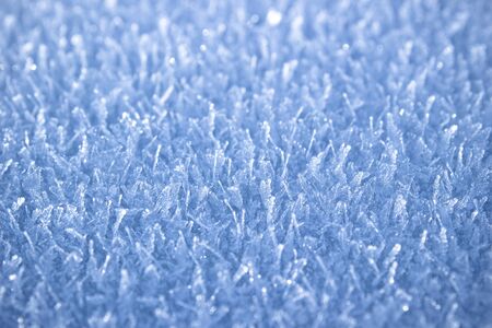 Texture of snow-white snowflakes on the surface. Freshly fallen snow with a beautiful texture. Beautiful frosty snow pattern in macro. Winter Wallpaper with frosty snowflakes.の写真素材