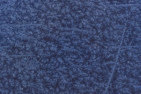 Texture of snow-white snowflakes on the surface. Beautiful frosty snow pattern on the window. Winter...