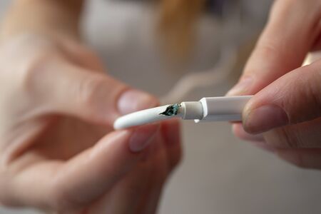 Broken phone charging wire. a person is holding a damaged wire.
