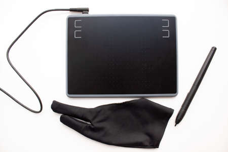 A graphic tablet with devices for working on a computer. A wired tablet with a touch pen and a glove...