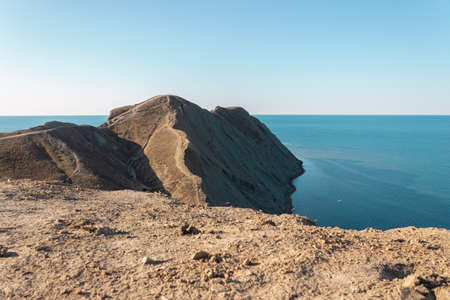 The edge of the mountain cliff. A mountain peak. A steep cliff on the sea coast. A steep mountain on...