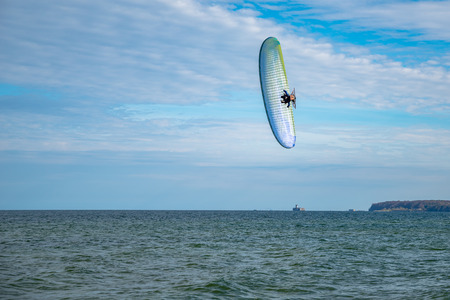 Flying paragliding on the beachの写真素材
