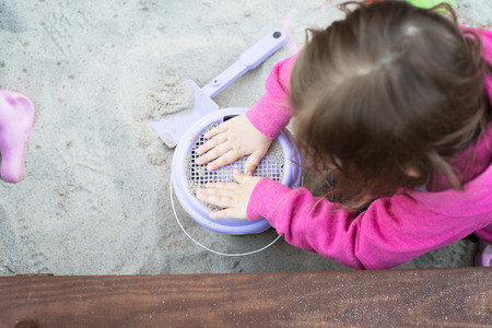 The child is playing in the sandboxの写真素材
