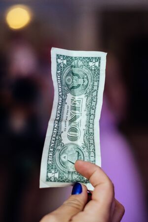 One dollar in a woman's handの写真素材