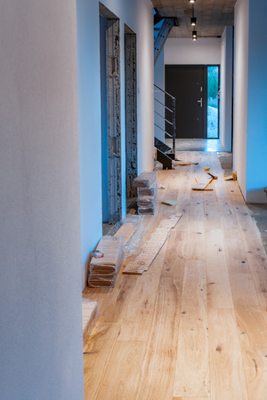 Laying a wooden floor in a new homeの写真素材