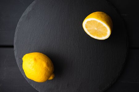 Fresh lemon cut in half on a black backgroundの写真素材