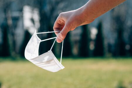 woman holds a medical mask in her handの写真素材