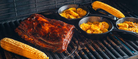 slow grilling of ribs with bacon on the grillの写真素材