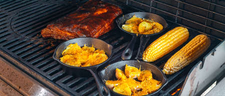 slow grilling of ribs with bacon on the grillの写真素材