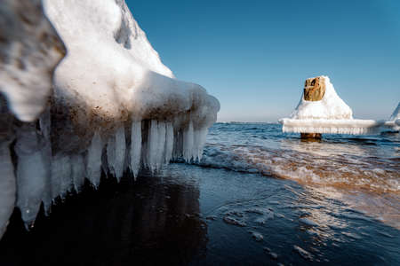 frozen piles on the waterの写真素材