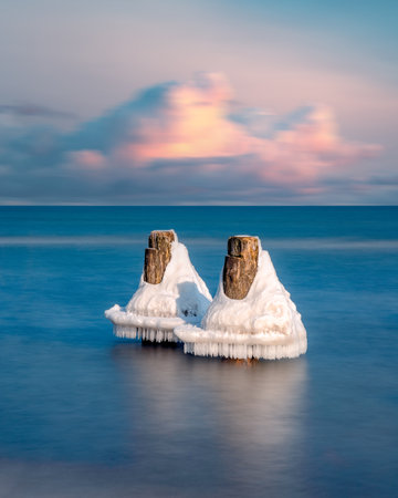 frozen piles on the waterの写真素材