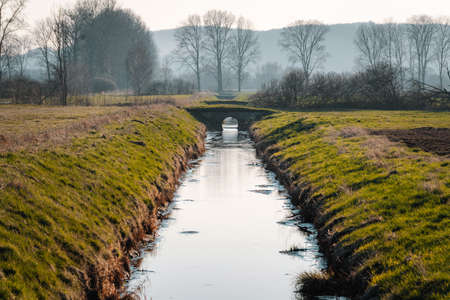 water canal in arable fieldsの写真素材