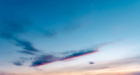 wispy clouds against the sky during sunsetの写真素材