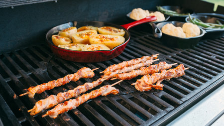 preparing dinner on a gas grillの写真素材