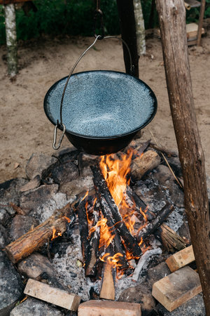 cooking food over a fire in a potの写真素材