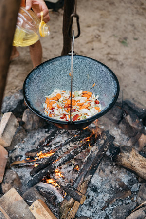 cooking food over a fire in a potの写真素材
