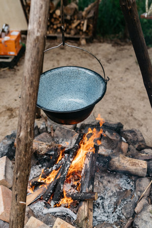 cooking food over a fire in a potの写真素材