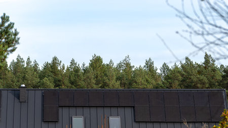 Installation of photovoltaic panels on the roof of a new houseの写真素材