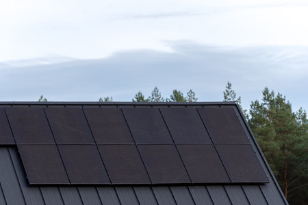 Installation of photovoltaic panels on the roof of a new houseの写真素材