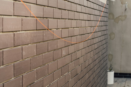 laying clinker tile on the facade of the houseの写真素材