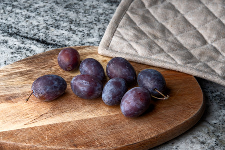 Hungarian plums on a cutting boardの写真素材