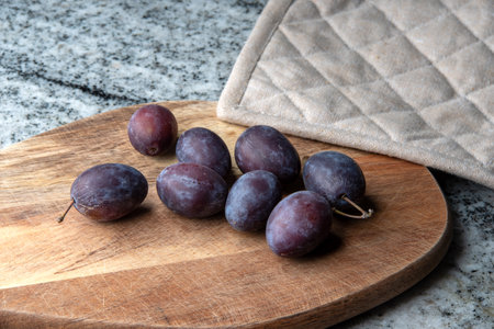 Hungarian plums on a cutting boardの写真素材